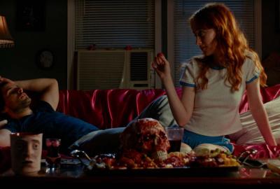 Ash (April Consalo) and Mark (Nate Wise) eating in Cannibal Mukbang