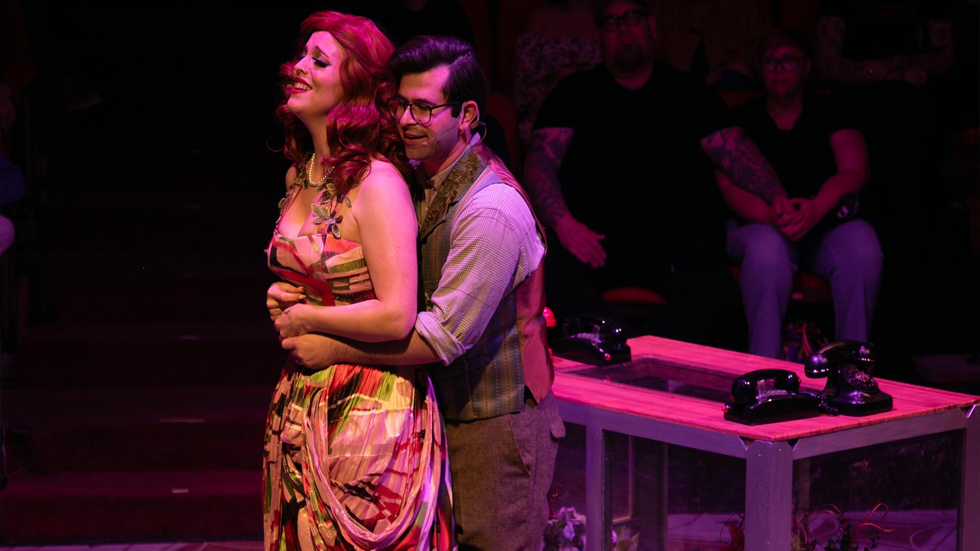 Couple hug in the Little House of Horrors Musical