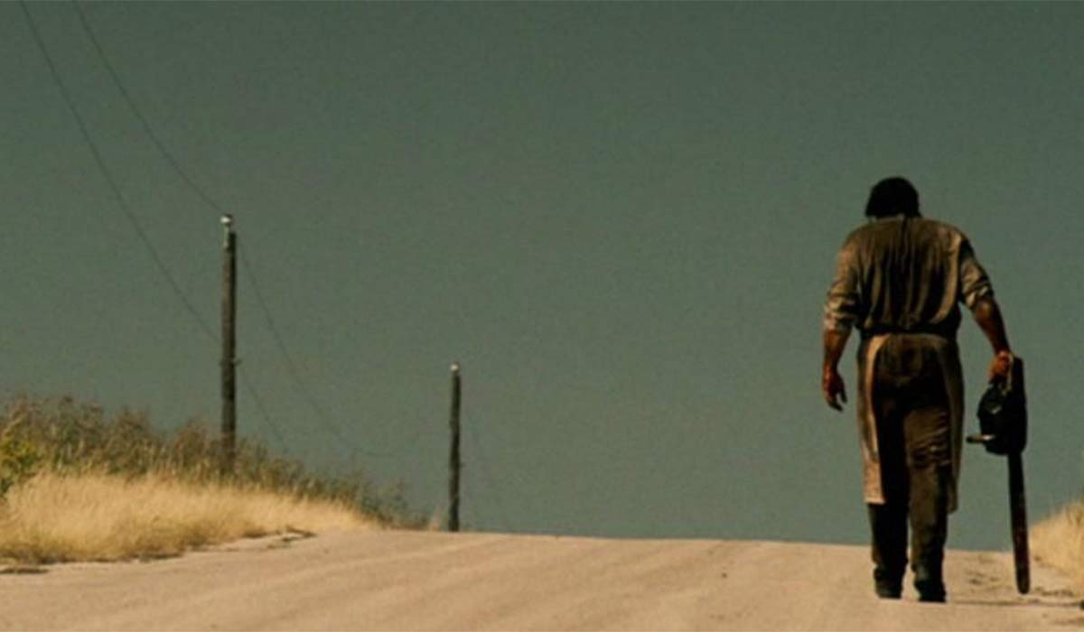 Leatherface walking up dirt road