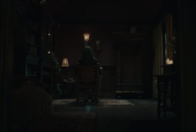 A silhouette sitting in a dark room